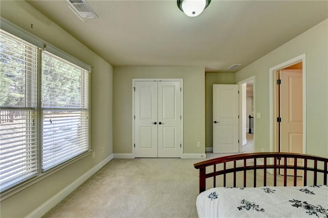 bedroom with a closet and light carpet