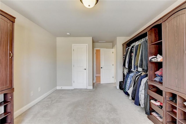 spacious closet featuring light carpet