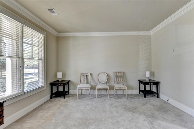 sitting room featuring crown molding and light colored carpet