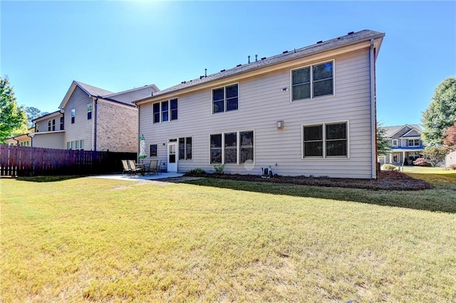 back of house featuring a patio and a lawn