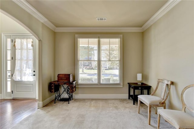 sitting room featuring light hardwood / wood-style floors and ornamental molding