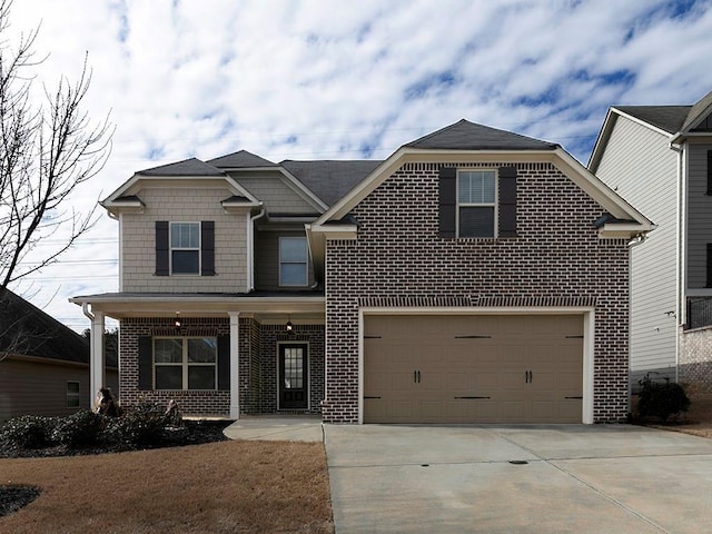 view of front of property featuring driveway, a garage, and brick siding