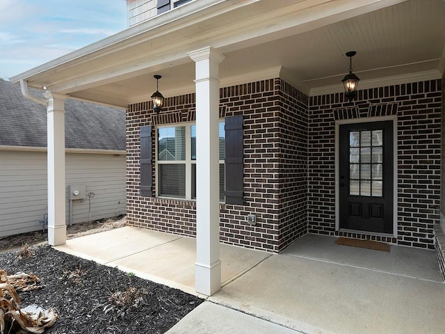 view of exterior entry with brick siding