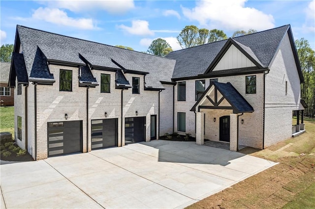 407 Thunder Rd, Buford, GA 30518 - view of front of house featuring a garage, concrete driveway, brick siding, and a shingled roof