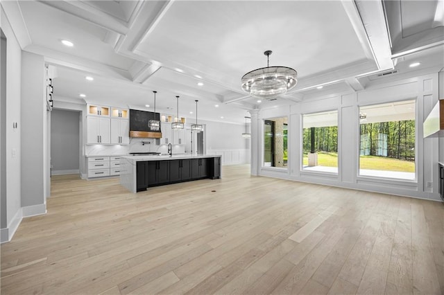 407 Thunder Rd, Buford, GA 30518 - unfurnished living room with light wood-type flooring, recessed lighting, a chandelier, ornate columns, and beam ceiling