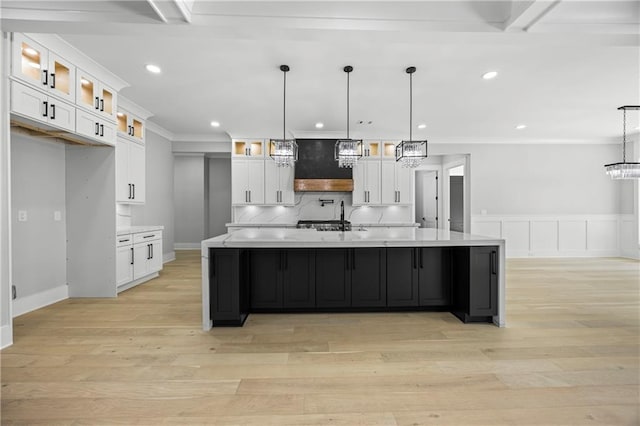 407 Thunder Rd, Buford, GA 30518 - kitchen with white cabinets, light wood-style floors, a large island, recessed lighting, and a sink