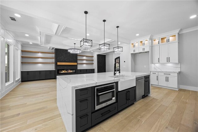 407 Thunder Rd, Buford, GA 30518 - kitchen featuring a sink, white cabinets, light wood-style floors, crown molding, and glass insert cabinets