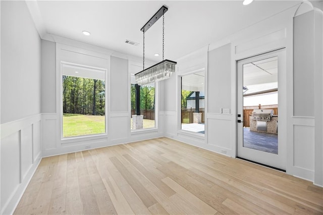 407 Thunder Rd, Buford, GA 30518 - unfurnished dining area with a decorative wall, light wood-style flooring, plenty of natural light, recessed lighting, and wainscoting