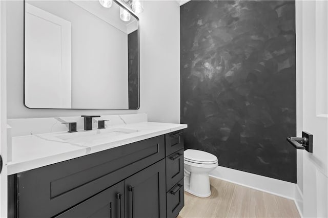 407 Thunder Rd, Buford, GA 30518 - bathroom with toilet, vanity, wood finished floors, and baseboards