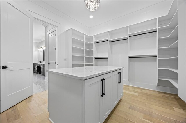 407 Thunder Rd, Buford, GA 30518 - spacious closet with light wood-style floors and a chandelier