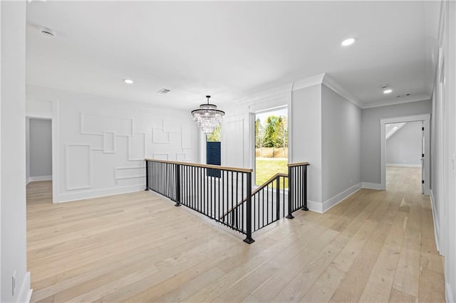 407 Thunder Rd, Buford, GA 30518 - hallway featuring an upstairs landing, crown molding, light wood-style flooring, a chandelier, and baseboards