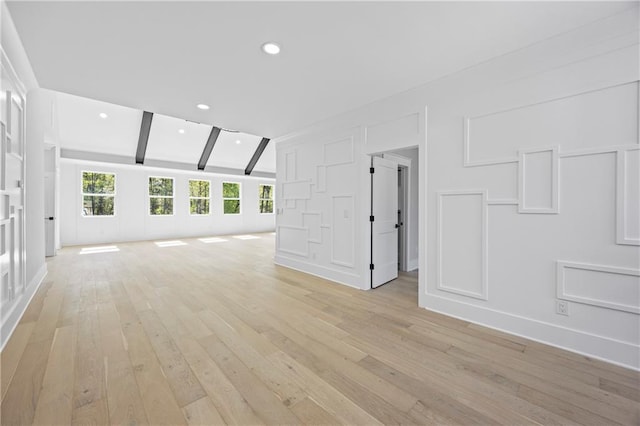 407 Thunder Rd, Buford, GA 30518 - empty room featuring light wood finished floors, beamed ceiling, recessed lighting, baseboards, and a decorative wall