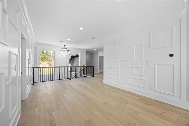 407 Thunder Rd, Buford, GA 30518 - empty room featuring light wood-style floors, recessed lighting, ornamental molding, a chandelier, and baseboards