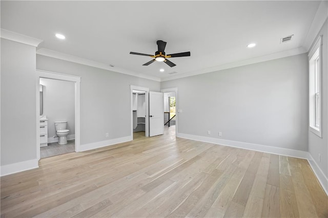 407 Thunder Rd, Buford, GA 30518 - unfurnished bedroom featuring crown molding, baseboards, light wood-style floors, recessed lighting, and a walk in closet