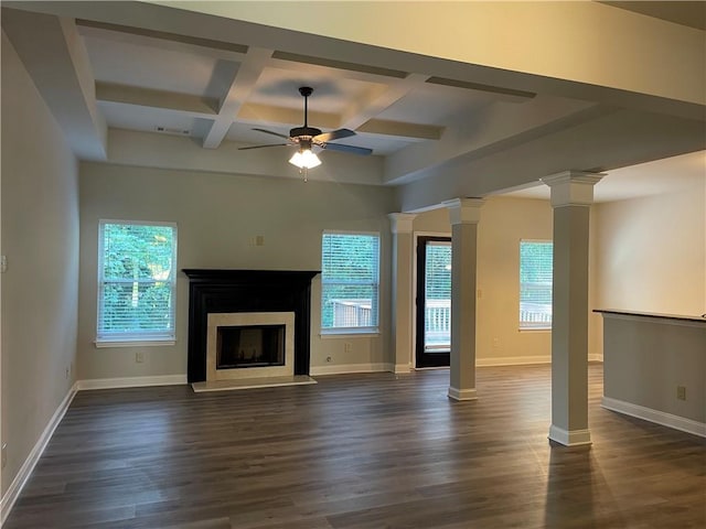 unfurnished living room with coffered ceiling, ornate columns, ceiling fan, a healthy amount of sunlight, and beam ceiling