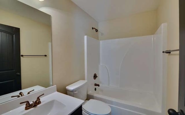 full bathroom with vanity, shower / bathtub combination, and toilet