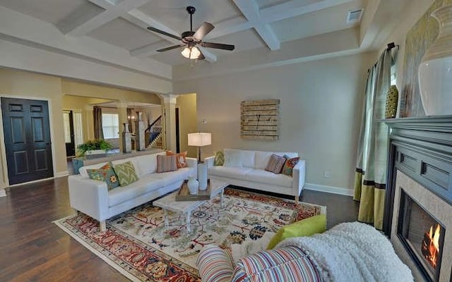 living room with coffered ceiling, dark hardwood / wood-style flooring, and beamed ceiling