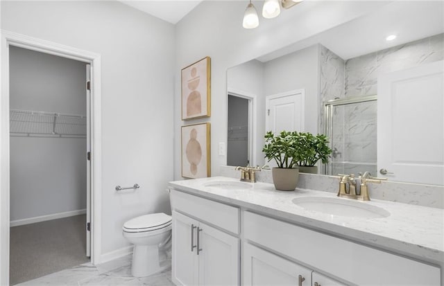 bathroom featuring vanity, toilet, and a shower with shower door