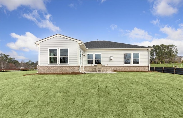 back of property featuring a patio area and a lawn