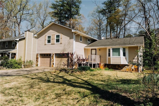 tri-level home with a front lawn, a garage, and concrete driveway