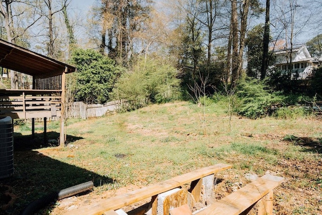 view of yard featuring fence and a deck