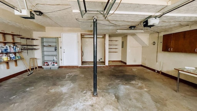 garage with a garage door opener and baseboards
