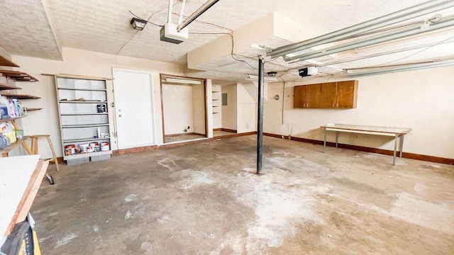 garage with a garage door opener and baseboards