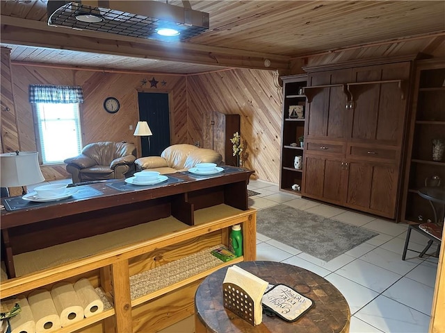 interior space featuring wood walls, light tile patterned flooring, a closet, and wooden ceiling