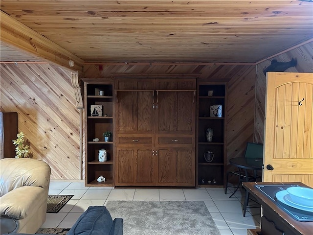 living room with light tile patterned floors, wood ceiling, and wooden walls