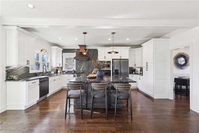 kitchen with a kitchen island, black dishwasher, stainless steel fridge, backsplash, and hanging light fixtures