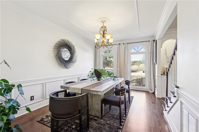 dining room with ornamental molding, dark hardwood / wood-style floors, and an inviting chandelier