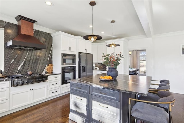 kitchen featuring white cabinetry, stainless steel appliances, and custom range hood