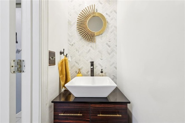 bathroom featuring vanity and decorative backsplash