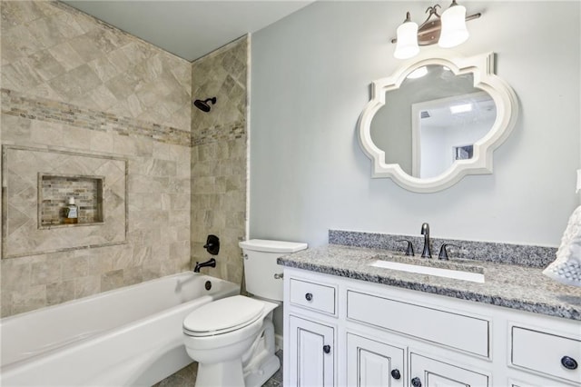 full bathroom featuring vanity, toilet, and tiled shower / bath combo