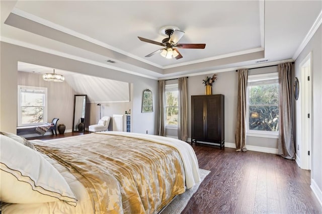 bedroom featuring ceiling fan, a raised ceiling, and multiple windows