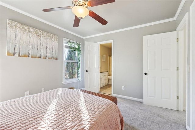 bedroom with ornamental molding, connected bathroom, light colored carpet, and ceiling fan