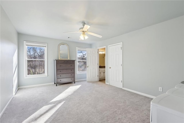 carpeted bedroom featuring ensuite bathroom and ceiling fan