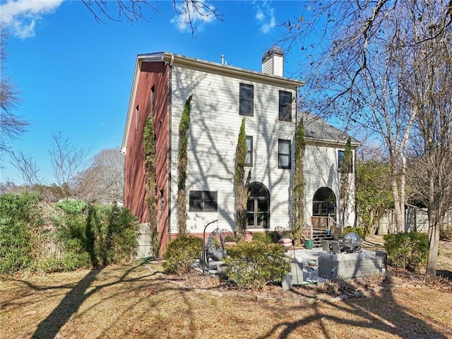 back of house with a yard and a patio