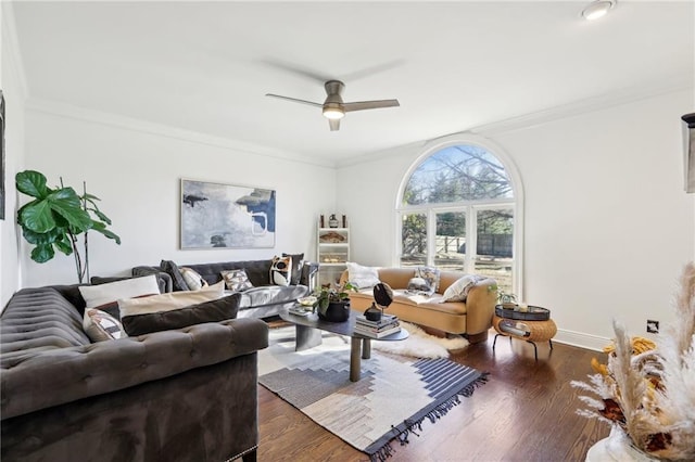 living room featuring ceiling fan, ornamental molding, and dark hardwood / wood-style floors