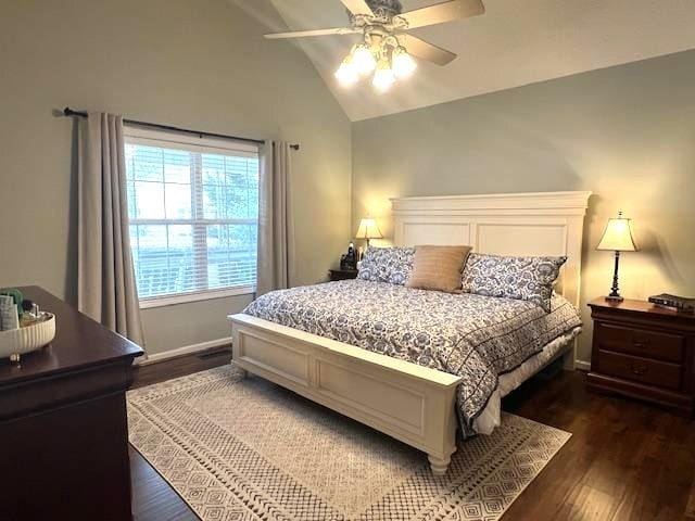 bedroom featuring vaulted ceiling, dark wood-type flooring, baseboards, and a ceiling fan