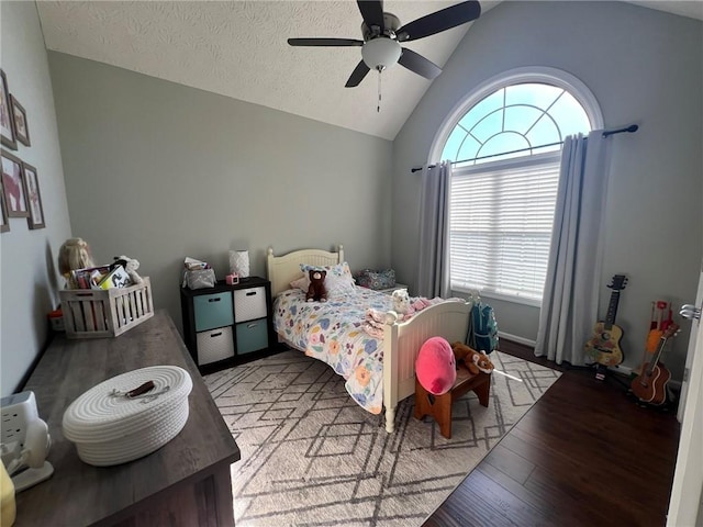 bedroom with lofted ceiling, wood finished floors, and ceiling fan