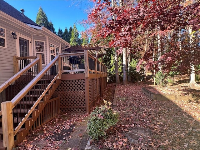 view of yard featuring a deck, stairway, and a pergola