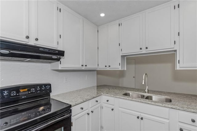 kitchen featuring electric range, a sink, white cabinets, and under cabinet range hood