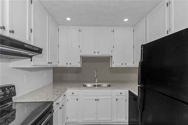 kitchen with white cabinetry, a sink, under cabinet range hood, and black appliances