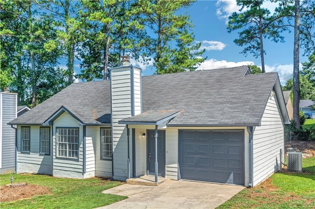 view of front of property featuring a garage, concrete driveway, a chimney, a front lawn, and central AC