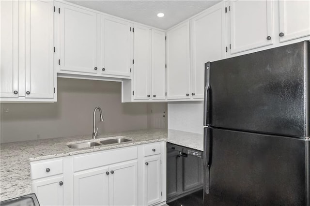 kitchen with light stone counters, recessed lighting, white cabinets, a sink, and black appliances