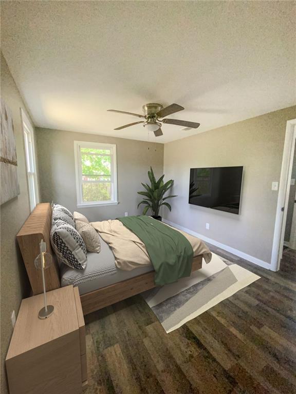bedroom with ceiling fan, baseboards, wood finished floors, and a textured ceiling