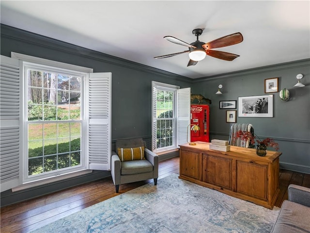 office featuring dark wood-type flooring, ornamental molding, and ceiling fan