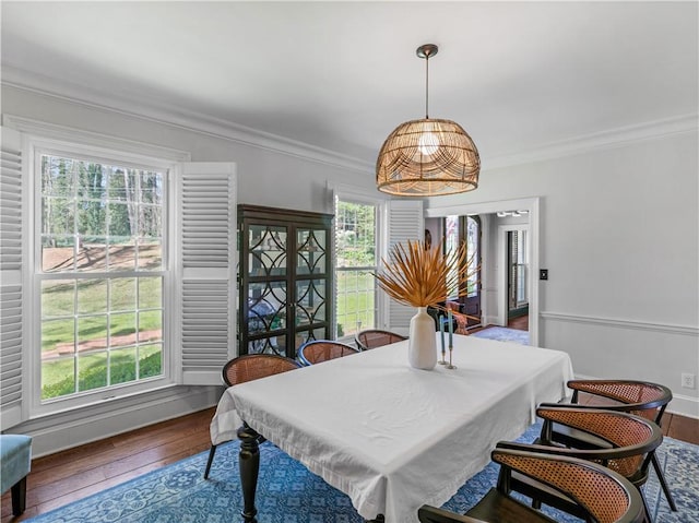 dining room with crown molding and hardwood / wood-style floors