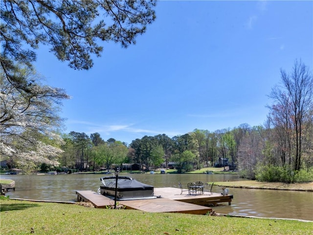 view of home's community with a water view and a boat dock